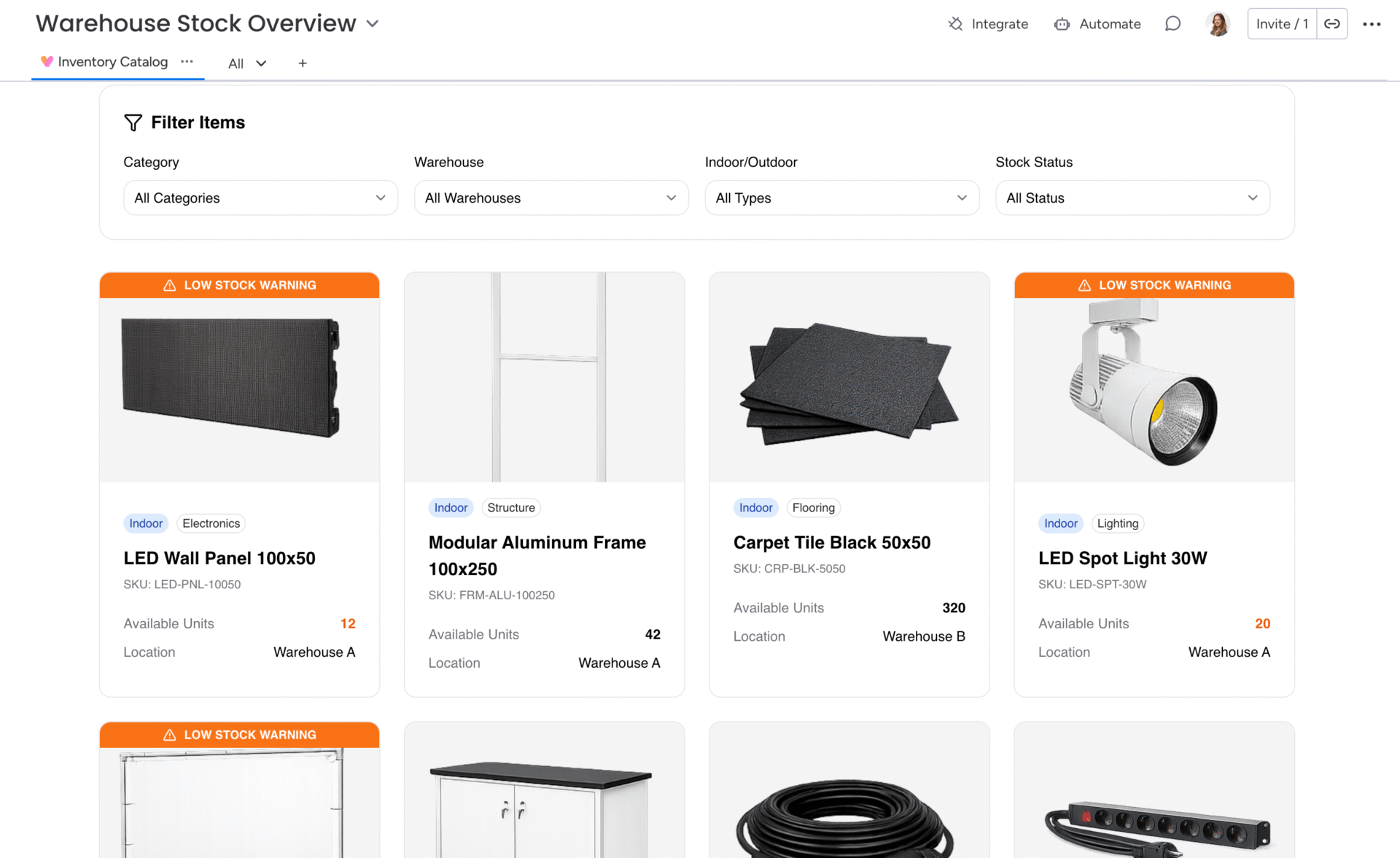 monday.com custom view built with monday vibe showing a webshop-style product inventory with product images, SKU, category tags, and low-stock alerts.